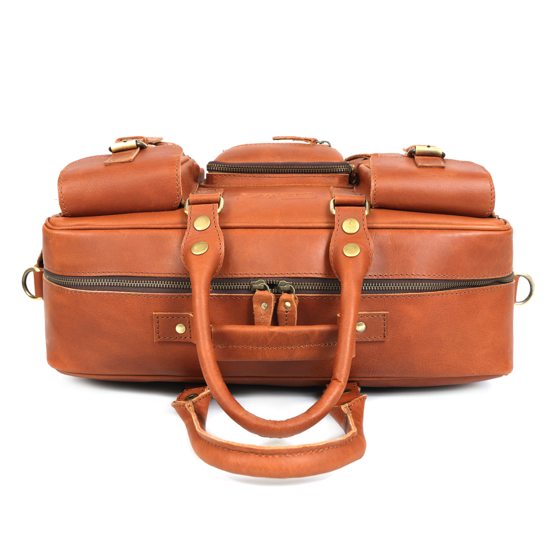 Brown leather suitcase with gold hardware on a white background