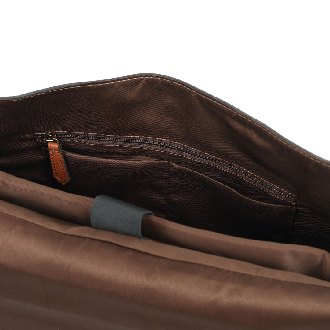 Brown leather bag with a zipper on a white background