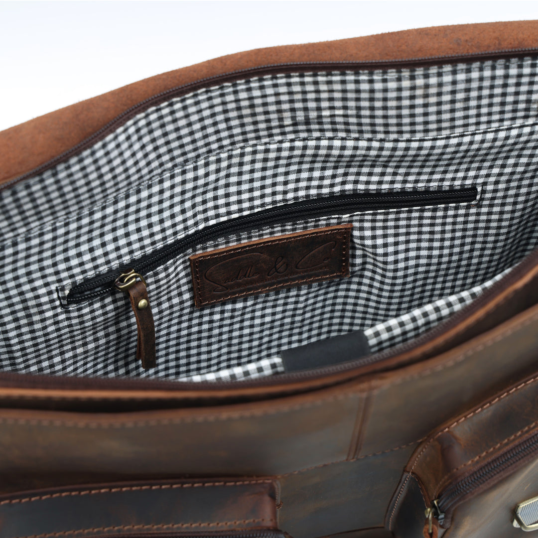 Brown leather bag with a checkered interior on a white background