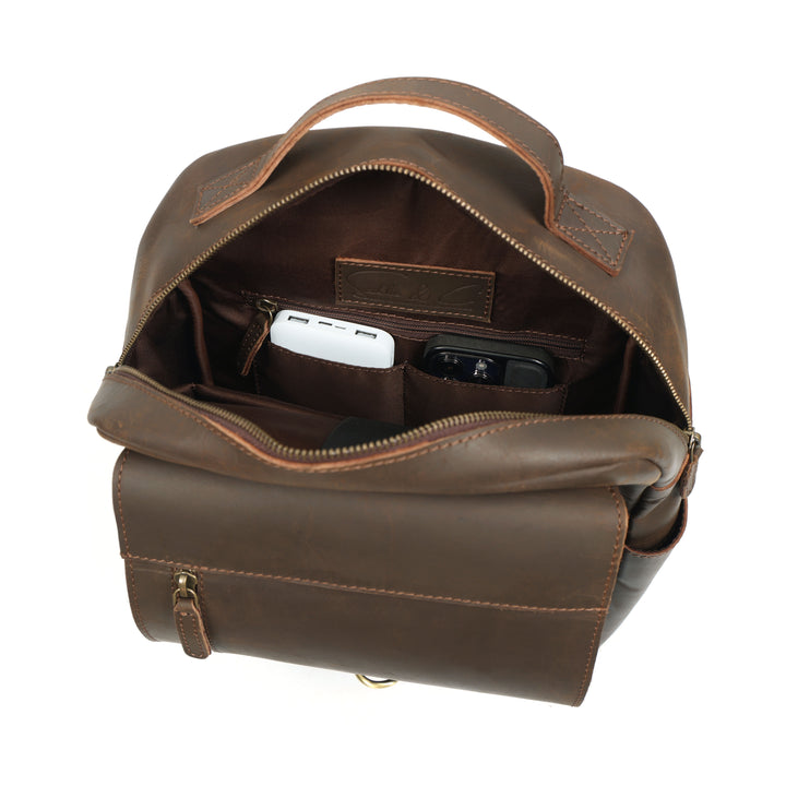 Brown leather backpack with interior compartments on a white background