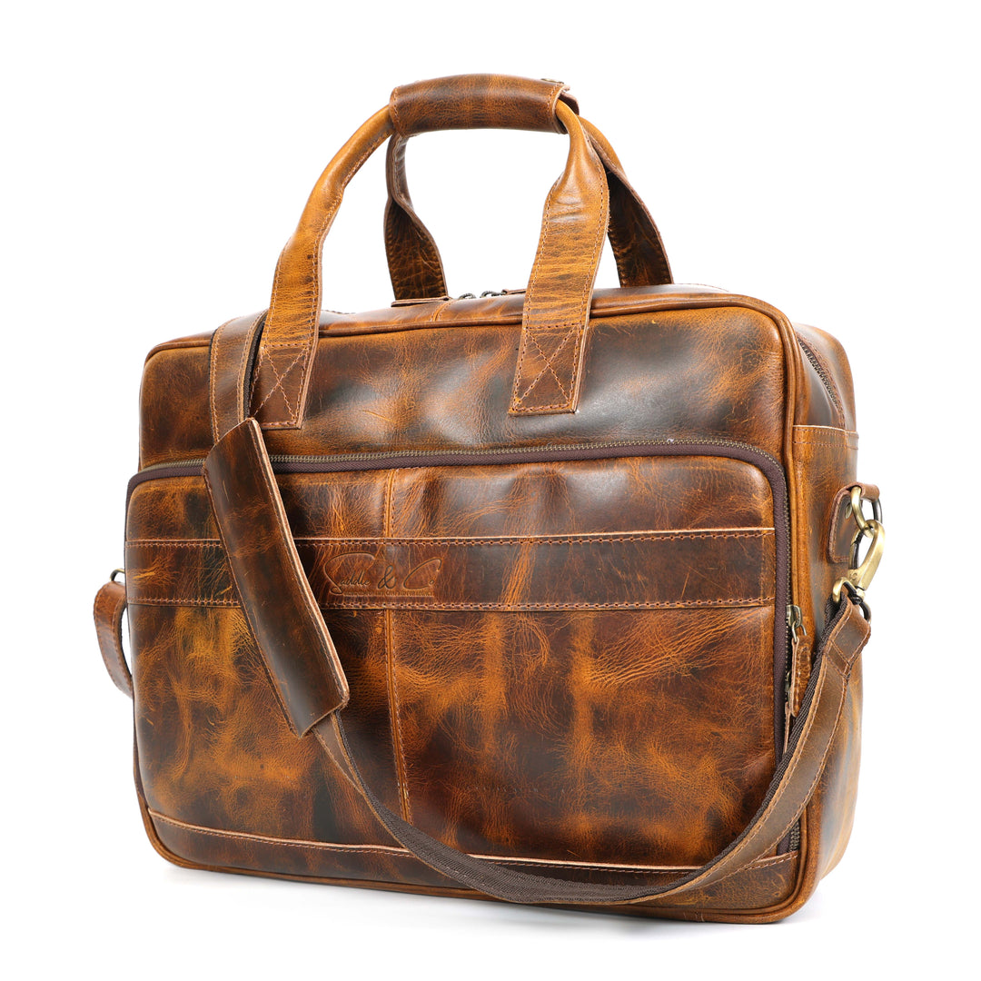 Brown leather briefcase with shoulder strap on a white background