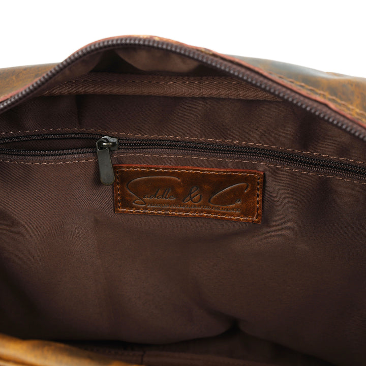 Close-up of a brown leather bag with a visible brand label on a white background