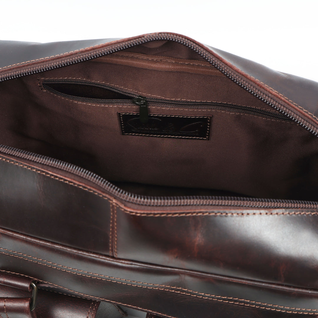 Close-up of a brown leather bag with visible stitching and a brand label.