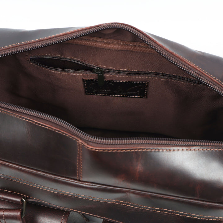 Close-up of a brown leather bag with visible stitching and a brand label.