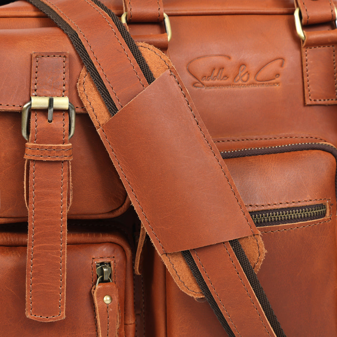 Close-up of a brown leather bag with visible stitching and brand logo.