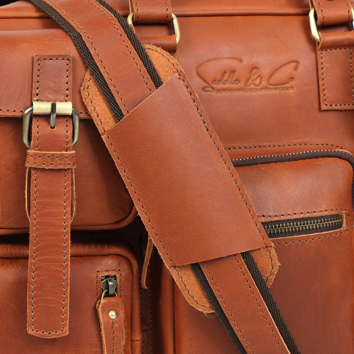 Close-up of a brown leather bag with visible stitching and brand logo.