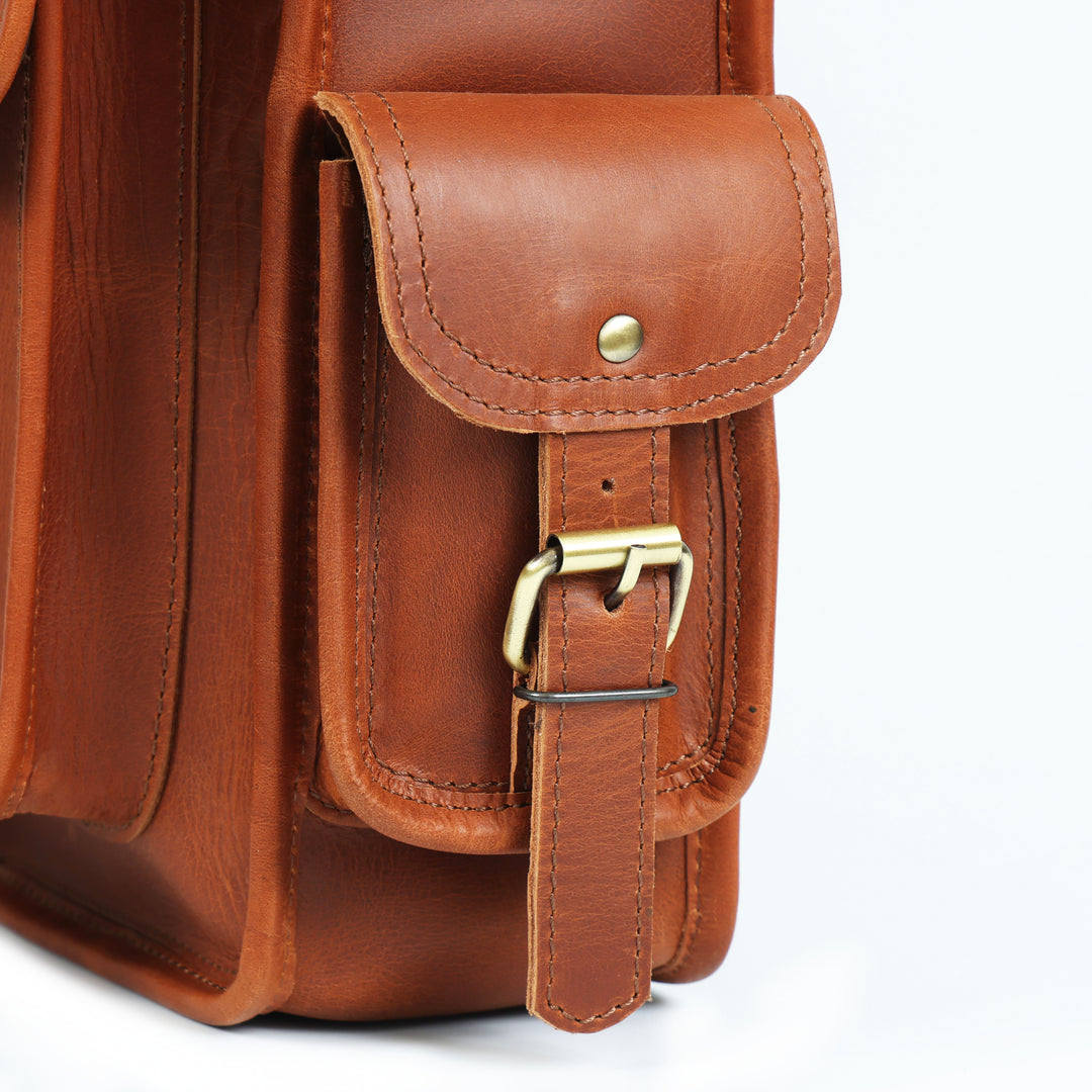 Close-up of a brown leather bag with a buckle on a white background