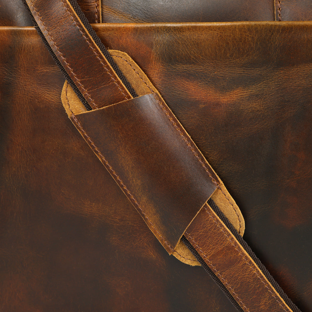 Close-up of a brown leather bag with a strap