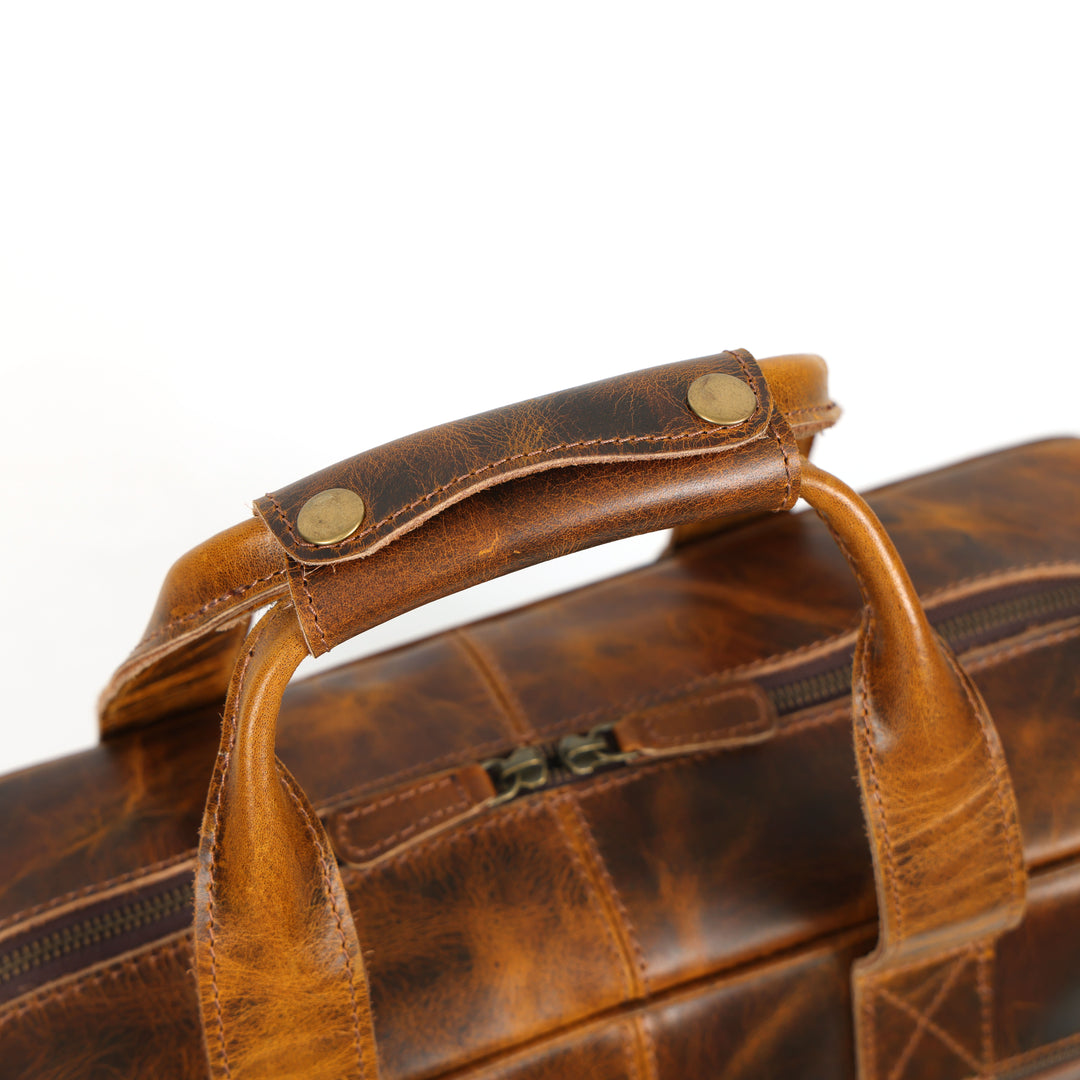 Close-up of a brown leather briefcase with visible texture and handles.