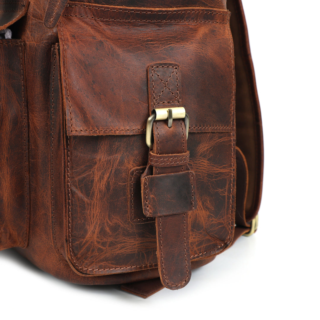 Brown leather bag with strap on a white background
