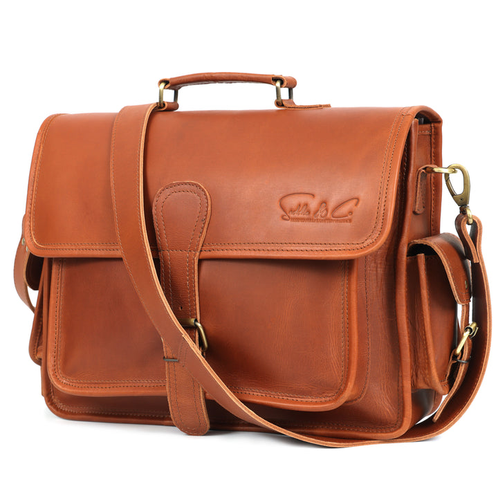 Brown leather satchel bag with shoulder strap on a white background