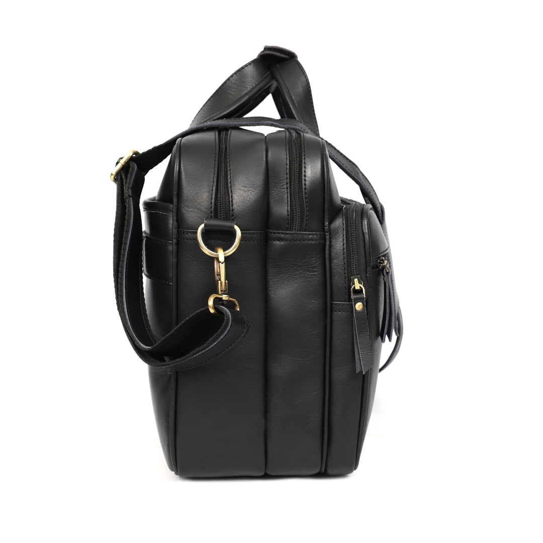 Black leather backpack with gold hardware on a white background