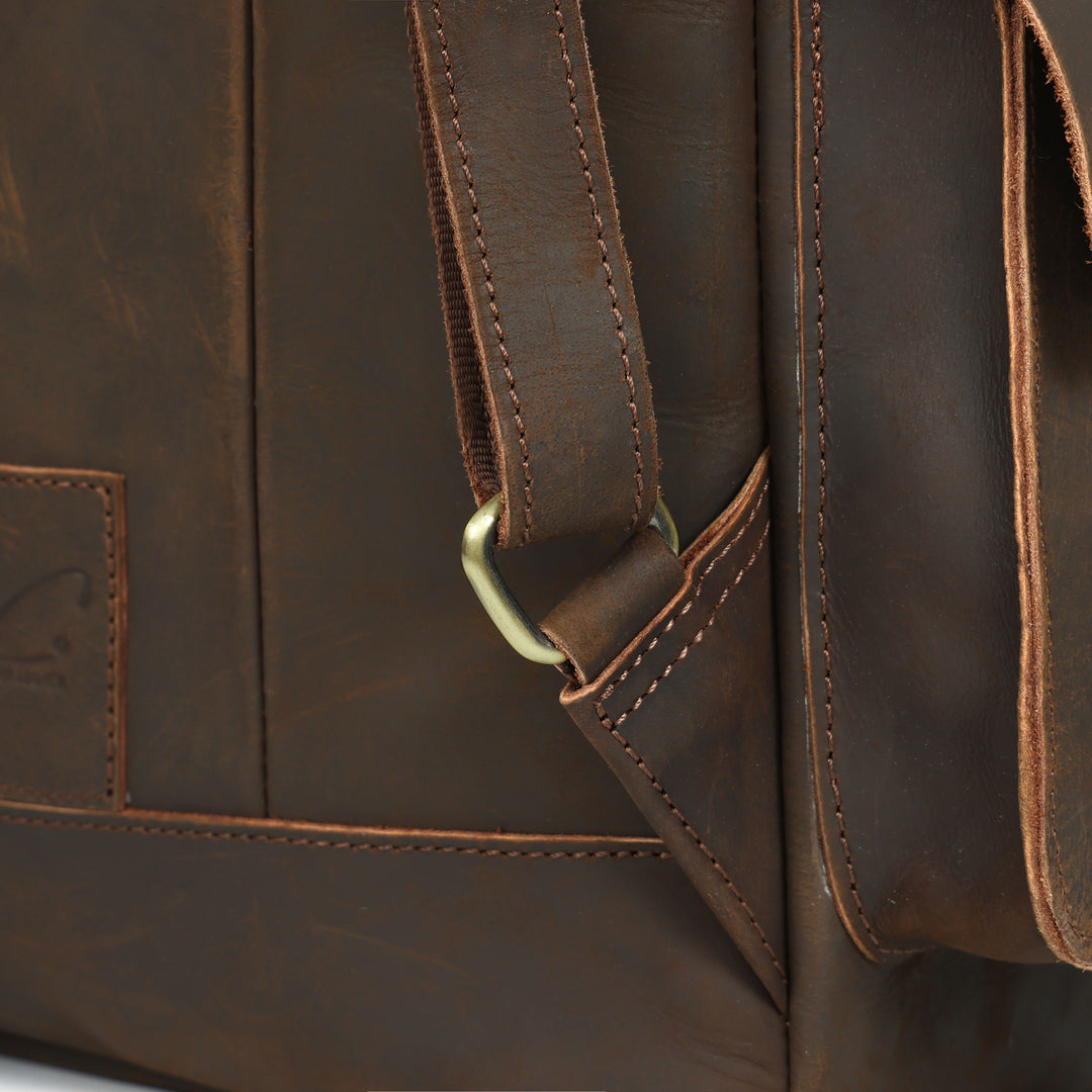 Close-up of a brown leather bag with visible stitching and strap.