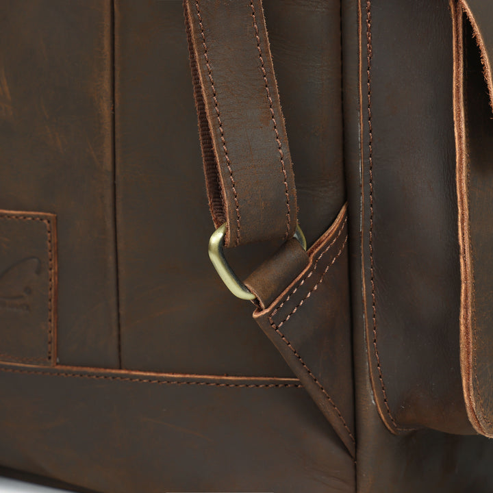 Close-up of a brown leather bag with visible stitching and strap.