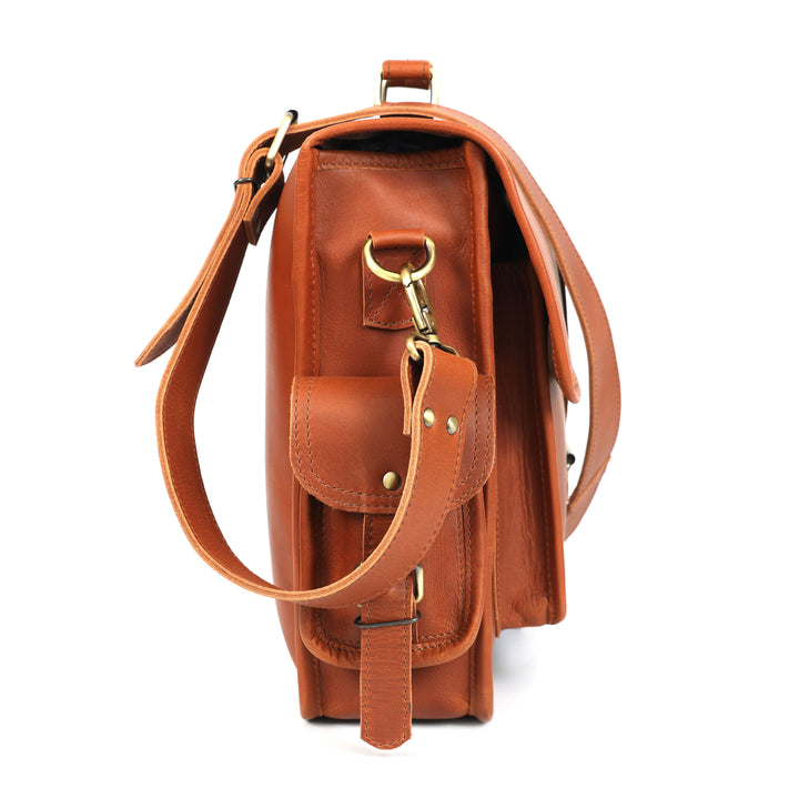 Brown leather bag with a strap on a white background