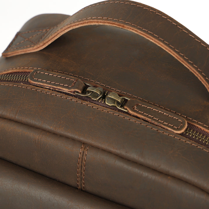 Close-up of a brown leather bag with a zipper