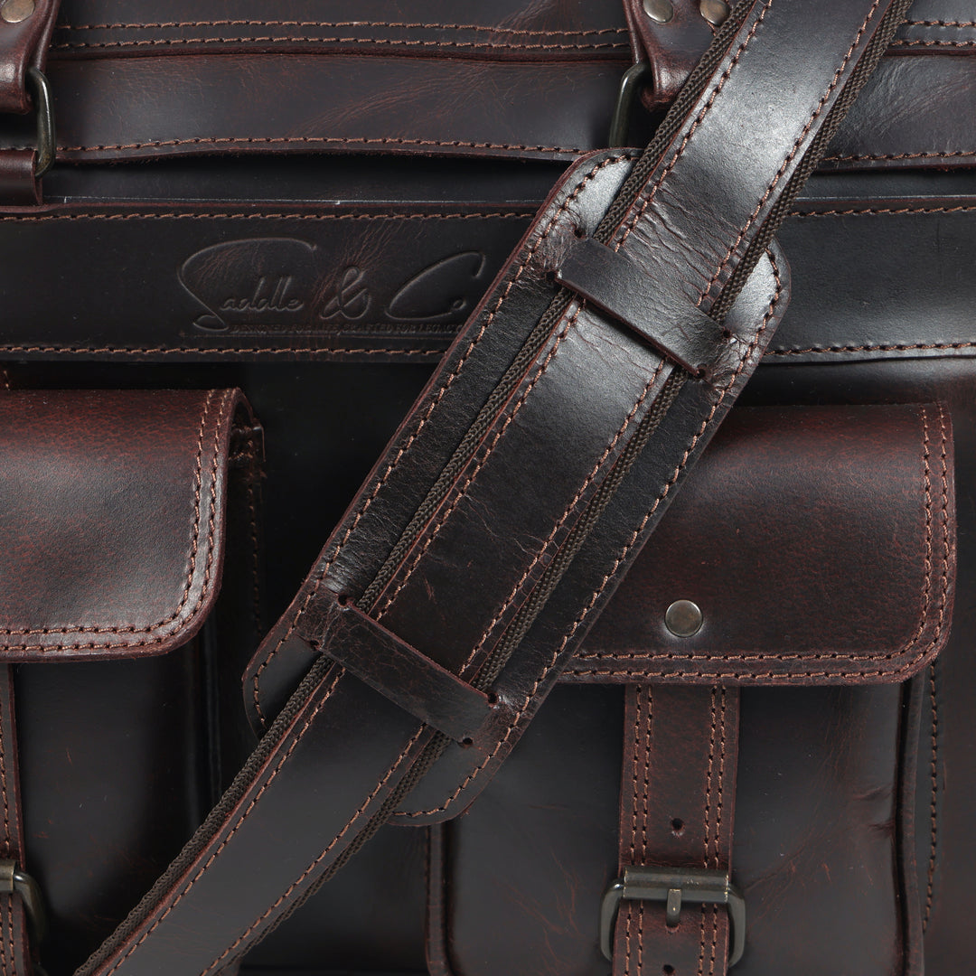 Close-up of a brown leather bag with visible stitching and brand logo.