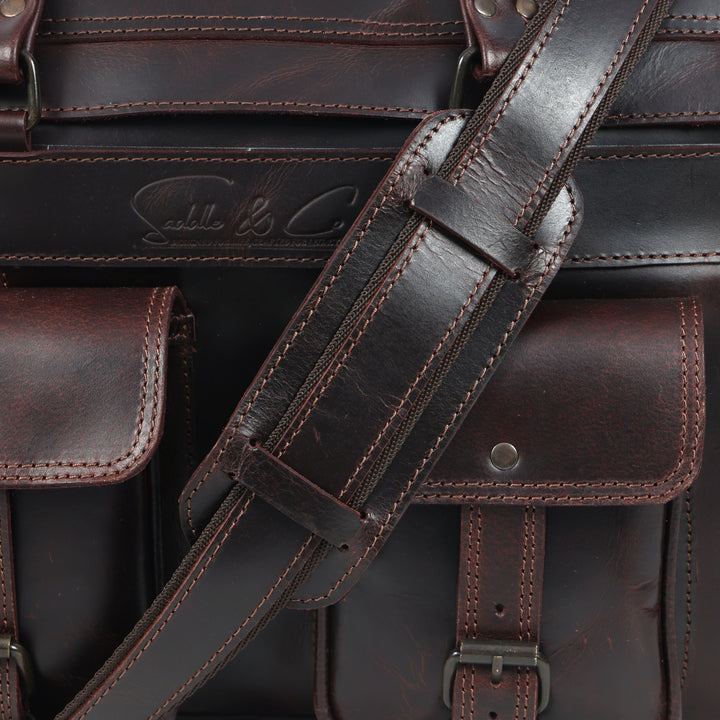 Close-up of a brown leather bag with visible stitching and brand logo.