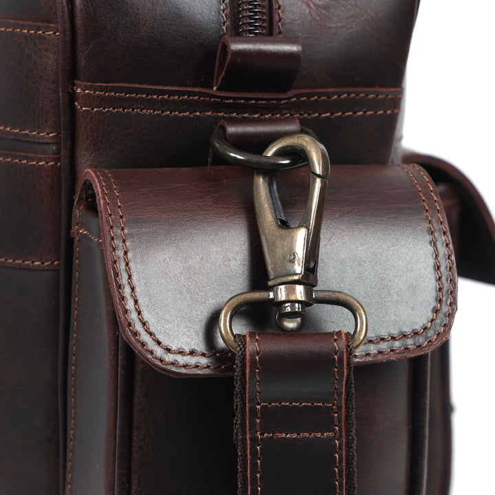 Close-up of a brown leather bag with a clasp on a white background