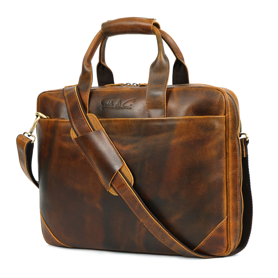 Brown leather briefcase with shoulder strap on a white background