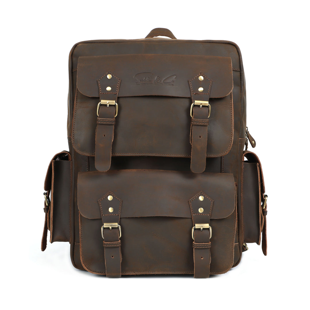 Brown leather backpack with gold buckles on a white background