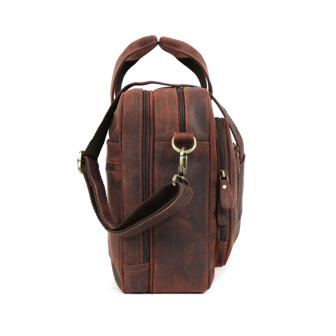 Brown leather bag with a shoulder strap on a white background