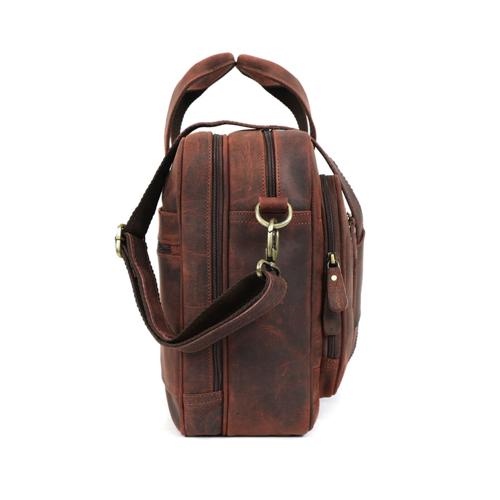 Brown leather bag with a shoulder strap on a white background