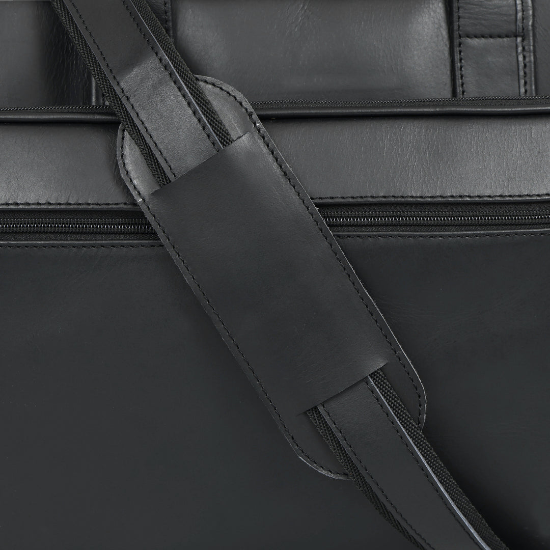 Close-up of a black leather bag with a strap