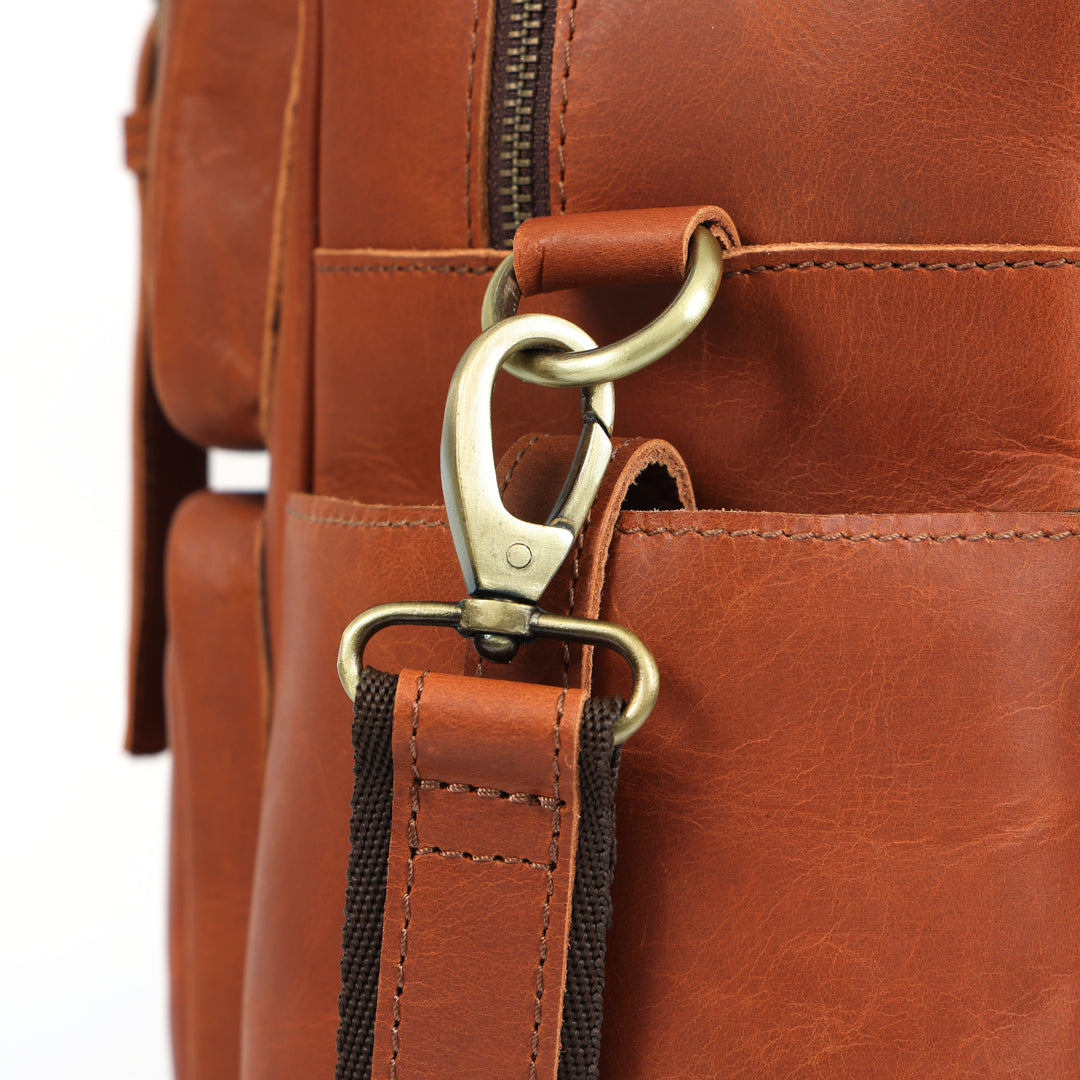 Close-up of a brown leather bag with a gold clasp on a white background