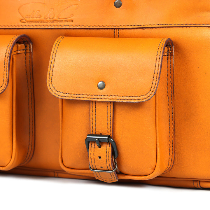 Close-up of an orange leather bag with a buckle on a white background