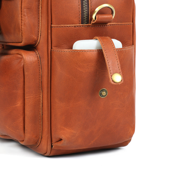 Brown leather backpack with a pocket on a white background