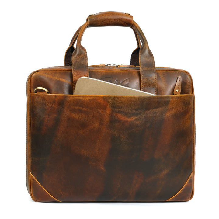 Brown leather briefcase with a laptop inside on a white background