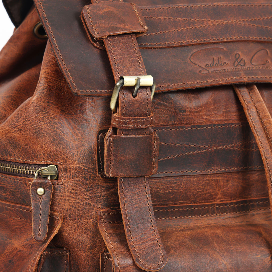 Close-up of a brown leather bag with visible stitching and brand logo.