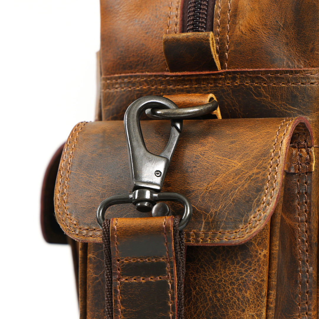 Close-up of a brown leather bag with a metal clasp on a white background