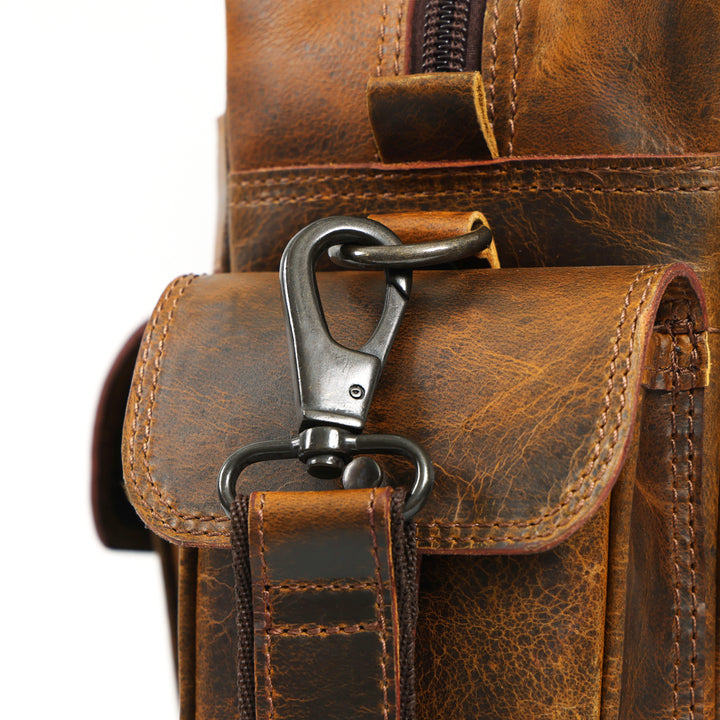 Close-up of a brown leather bag with a metal clasp on a white background