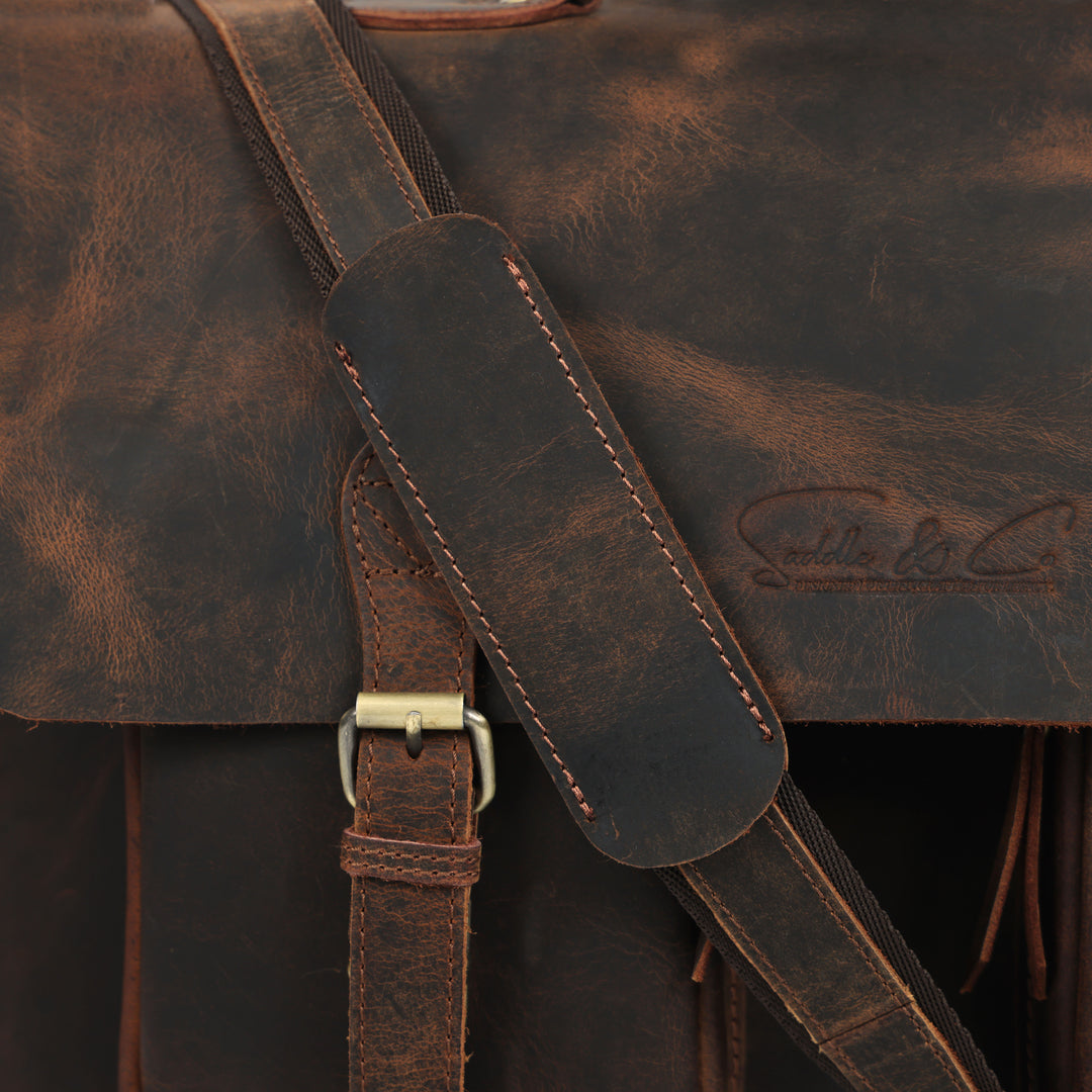 Close-up of a brown leather bag with visible stitching and brand logo.