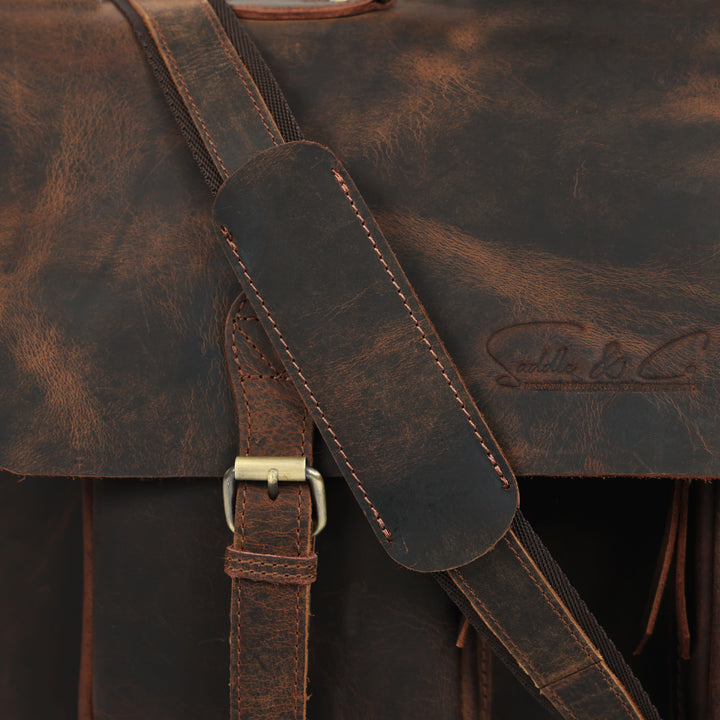 Close-up of a brown leather bag with visible stitching and brand logo.