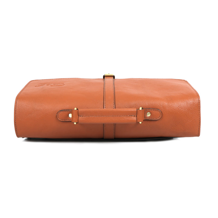 Brown leather travel roll with gold hardware on a white background