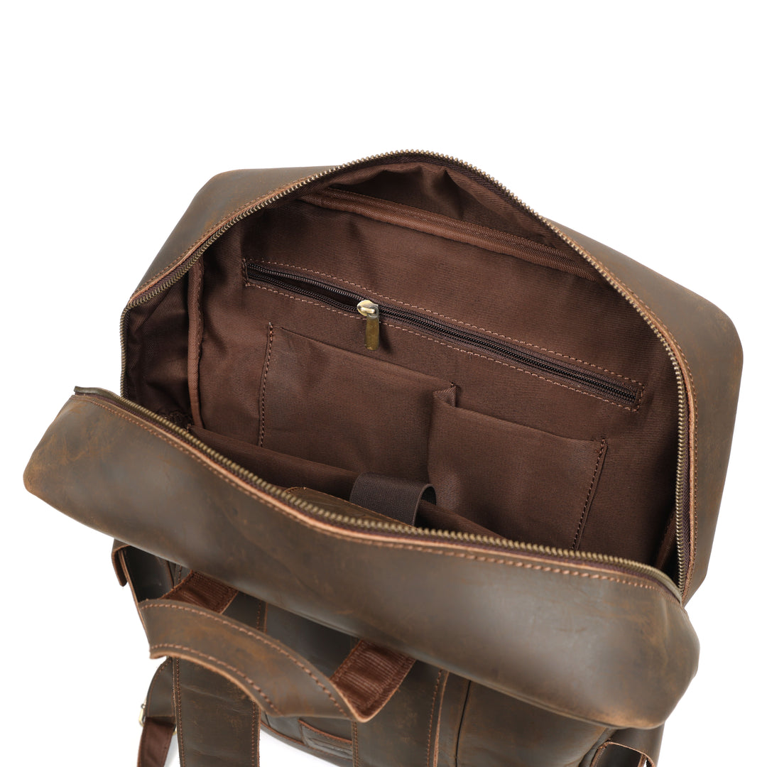 Brown leather backpack with open front pocket on a white background