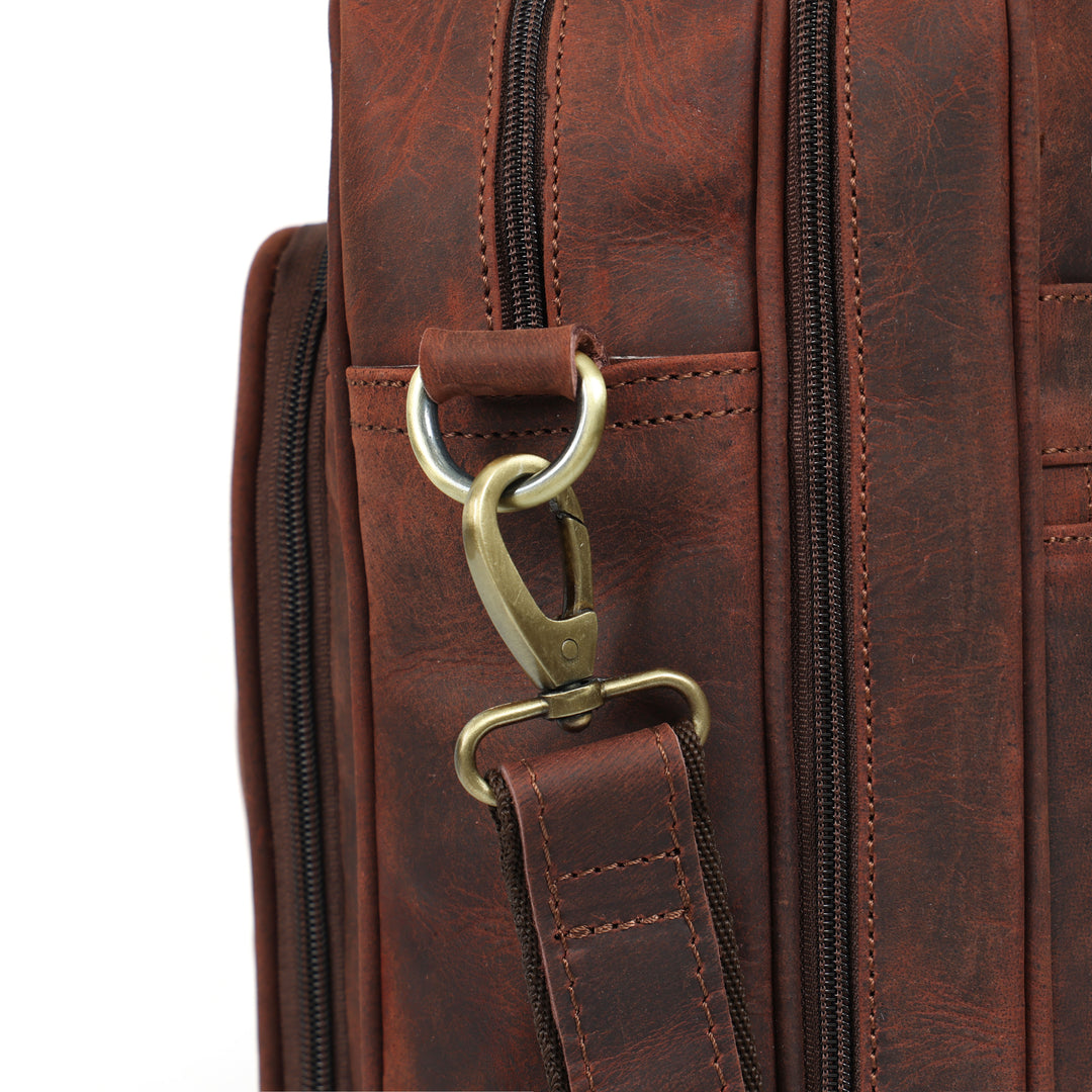 Close-up of a brown leather bag with a gold clasp on a white background