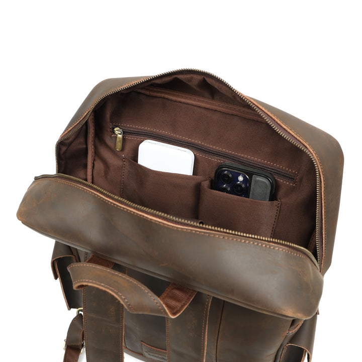 Brown leather backpack with interior compartments on a white background