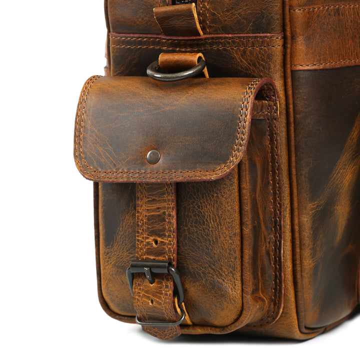 Brown leather bag with a strap on a white background