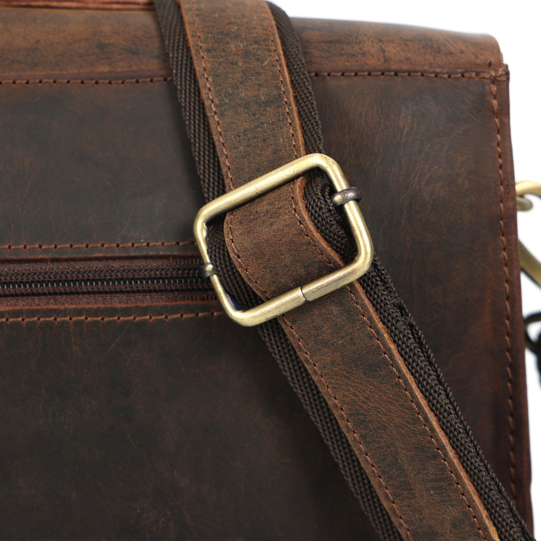 Close-up of a brown leather bag with a gold buckle on a white background