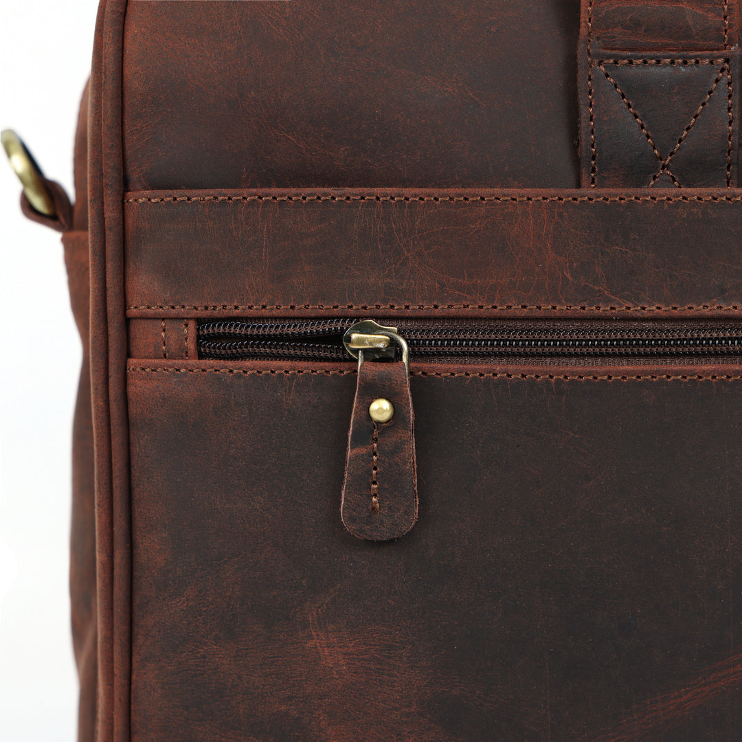 Close-up of a brown leather bag with a zipper