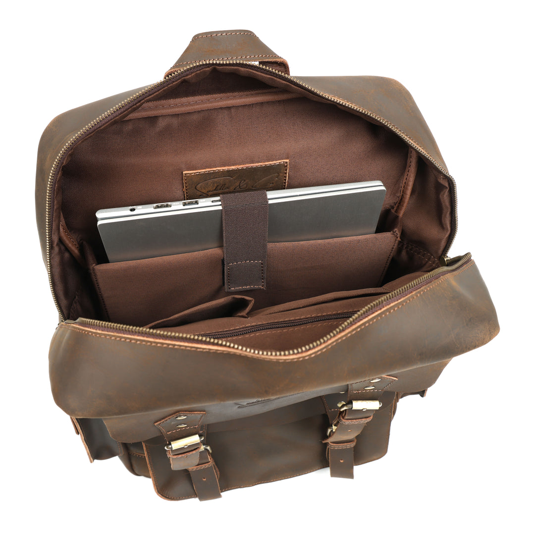 Brown leather backpack with a compartment holding a tablet on a white background