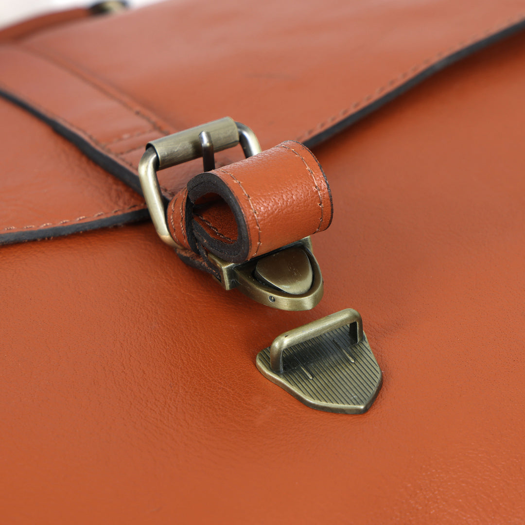 Close-up of a brown leather bag with a metal clasp