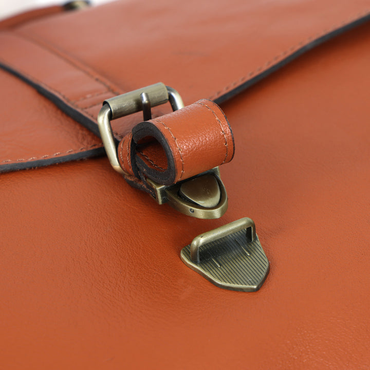 Close-up of a brown leather bag with a metal clasp