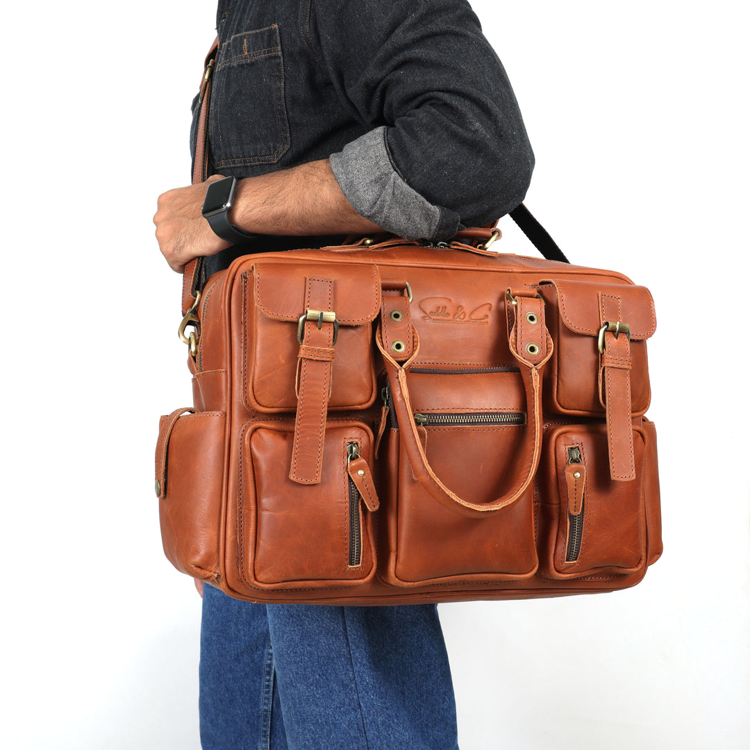 Brown leather bag carried by a person on a white background