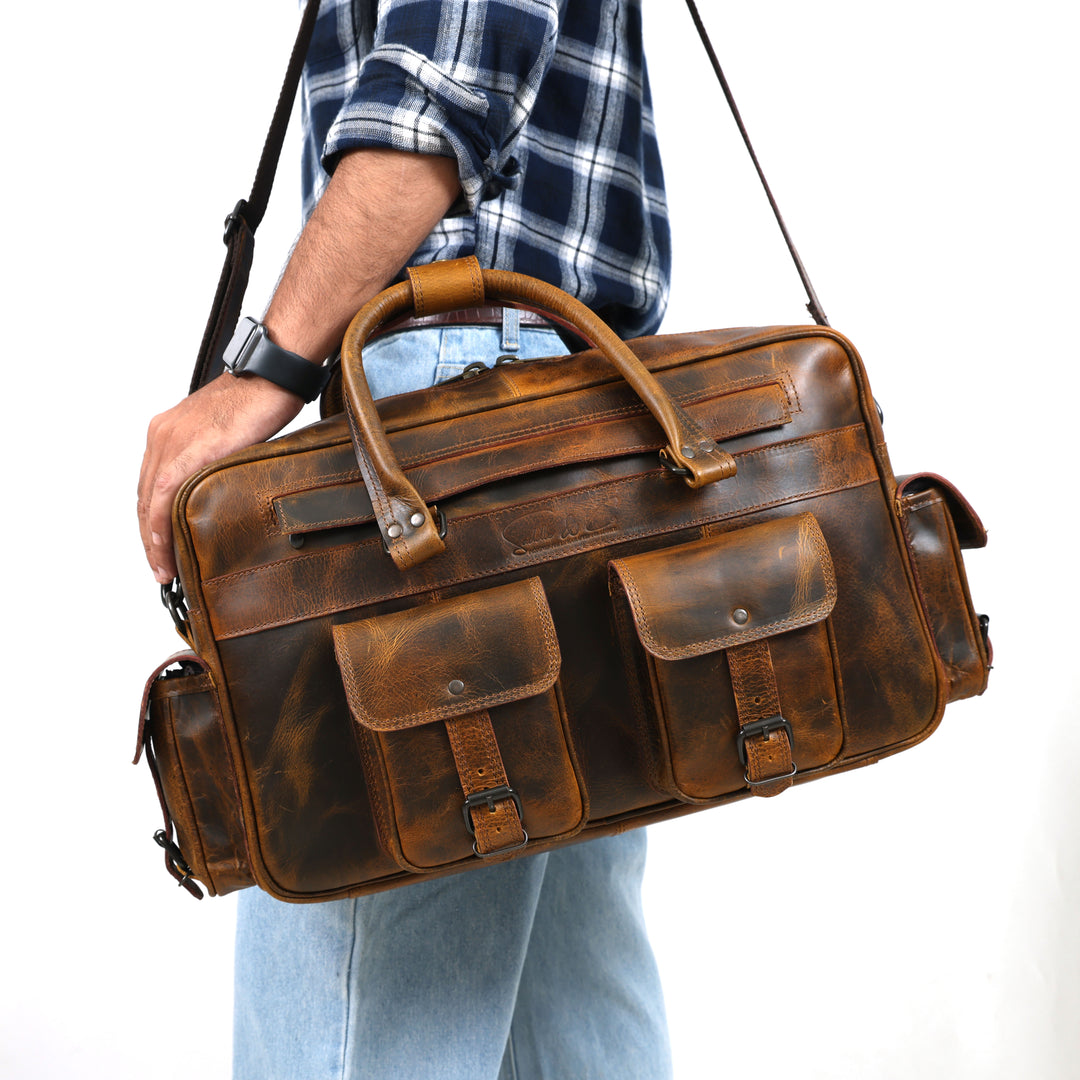 Person holding a brown leather briefcase against a white background