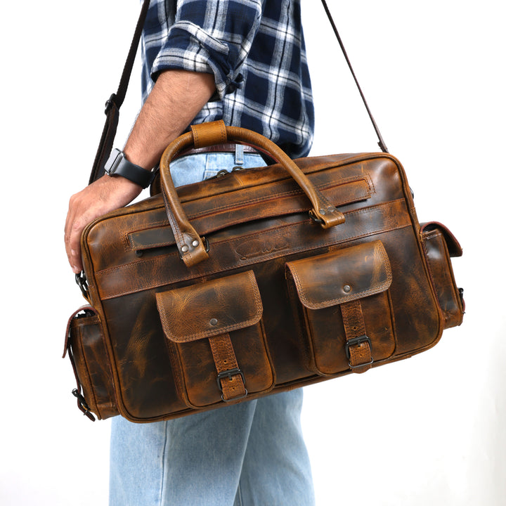 Person holding a brown leather briefcase against a white background